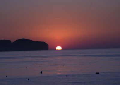 puesta de sol, mar, horizonte, acantilado, silueta, atardecer, cielo rojo, océano, costa, reflejo, agua, calma, paisaje marino, luz cálida, crepúsculo, playa, naturaleza, serenidad, fotografía de paisaje, litoral.